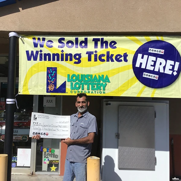 Ali Zadi, Superior Discount owner, poses with $20,000 lottery bonus check